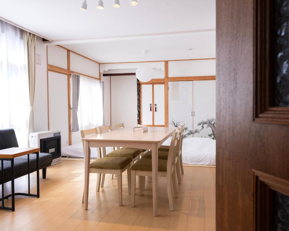 a dining room with a table and chairs at FURANO BnB in Furano