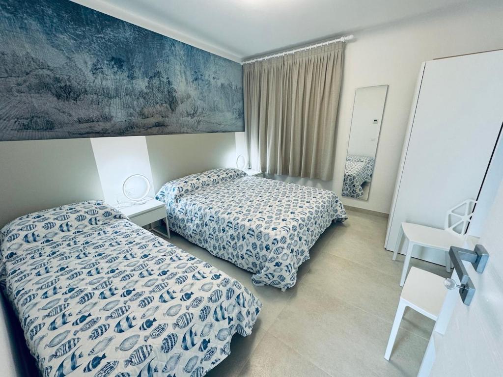 Ένα ή περισσότερα κρεβάτια σε δωμάτιο στο App4rent Villa Zanetti - Appartamenti con spiaggia privata frontemare