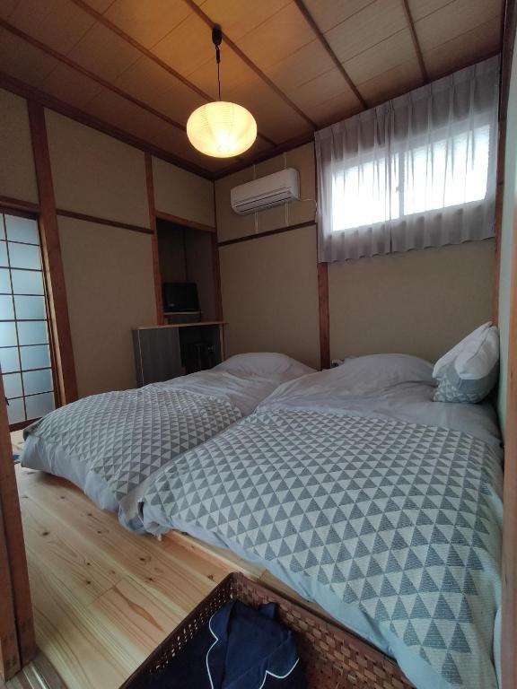 Postel nebo postele na pokoji v ubytování 敷島旅館