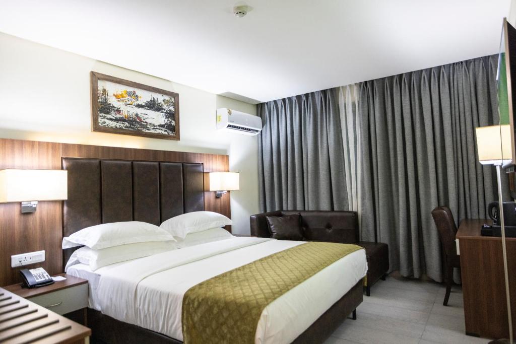 Ένα ή περισσότερα κρεβάτια σε δωμάτιο στο Jogor Hotel Ibadan