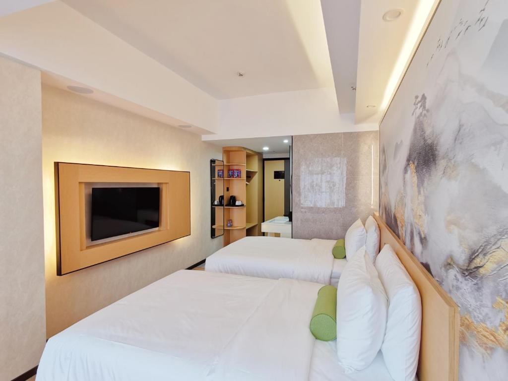Postel nebo postele na pokoji v ubytování Connar Hotel - Shenzhen Shawei