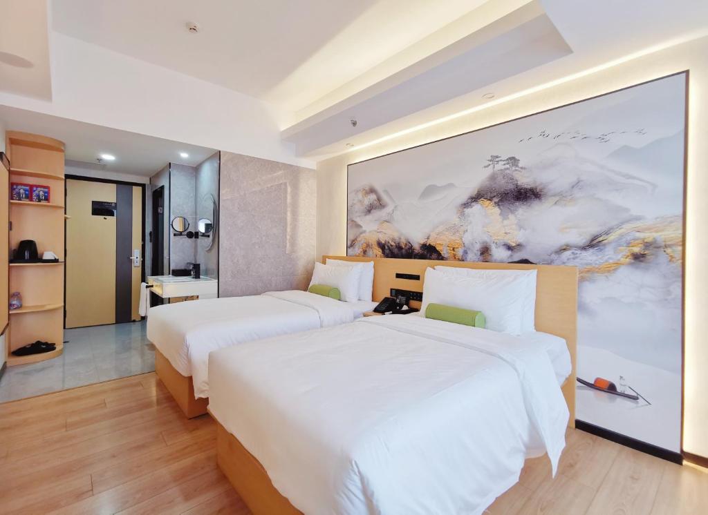 Postel nebo postele na pokoji v ubytování Connar Hotel - Shenzhen Shawei