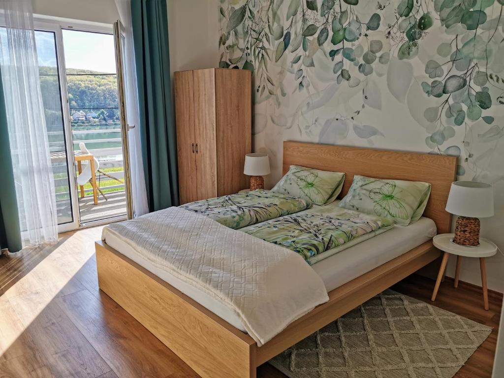 A bed or beds in a room at Life Apartman Orfű