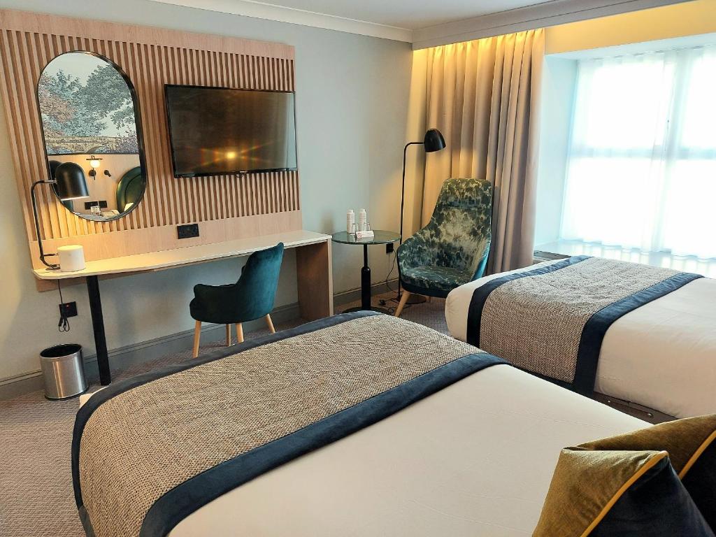 Postel nebo postele na pokoji v ubytování Menlo Park Hotel