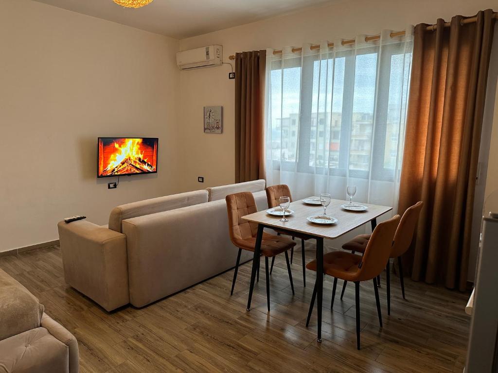 a living room with a table and a couch at Sea View Deluxe Apartment in Durrës