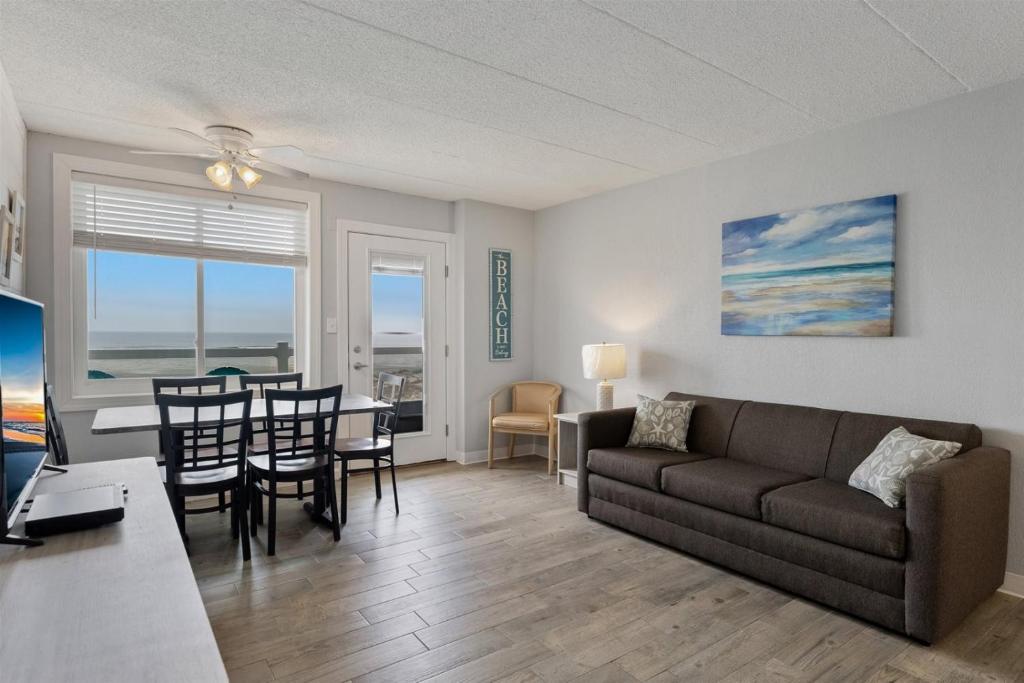 a living room with a couch and a table with chairs at 9103 Atlantic Ave, Unit 415 in Wildwood Crest