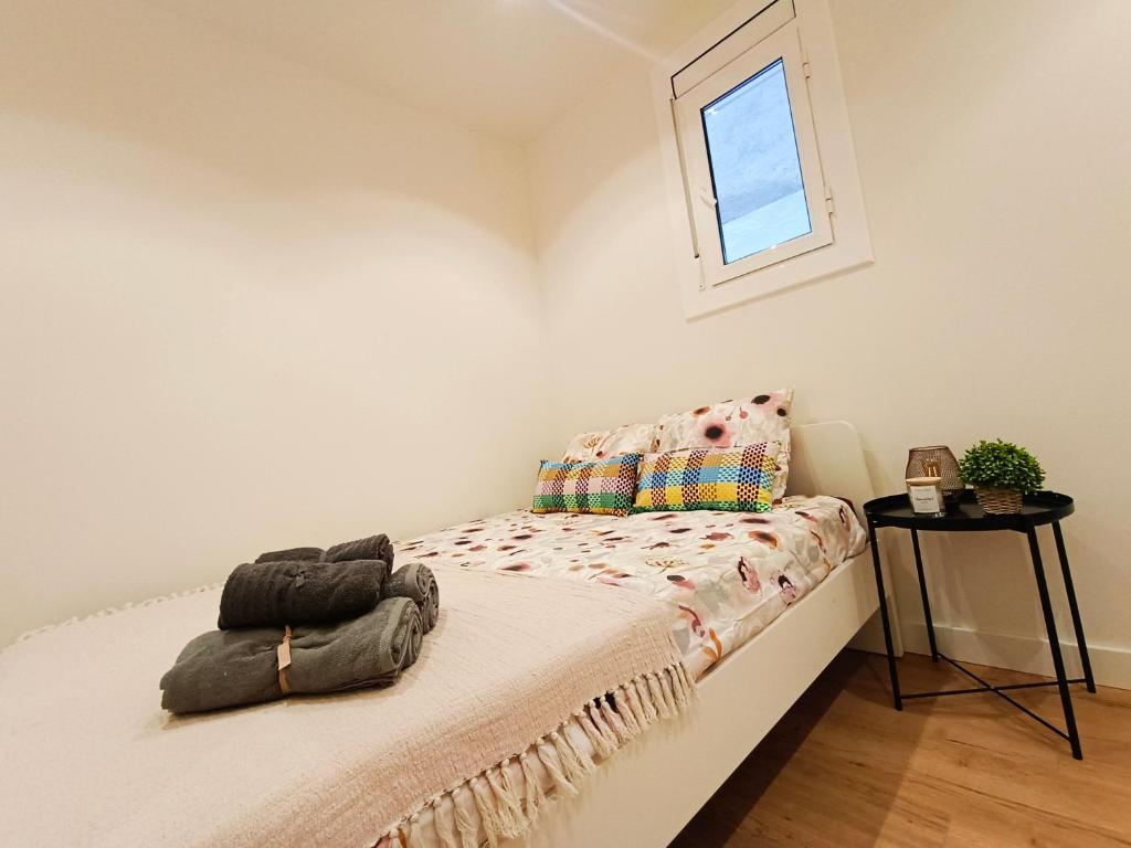 ein kleines Schlafzimmer mit einem Bett und einem Fenster in der Unterkunft El born private rooms in Barcelona