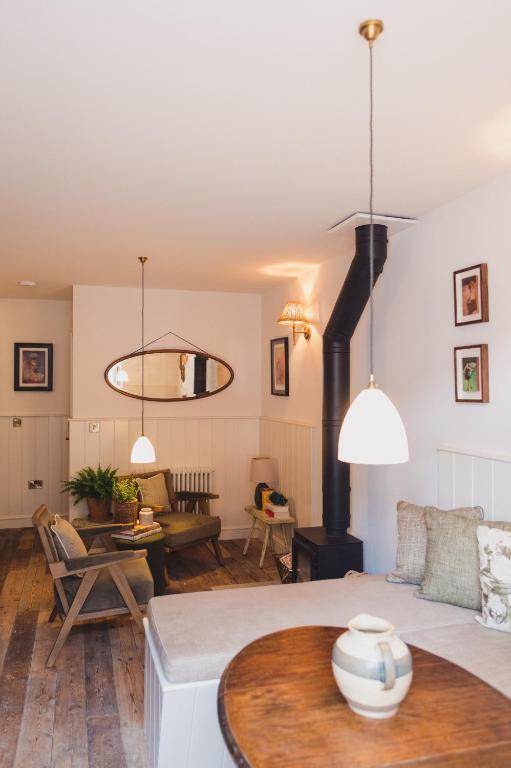 a living room with a couch and a table at Buckingham Mews_Flint Cottage 2 in Broadstairs
