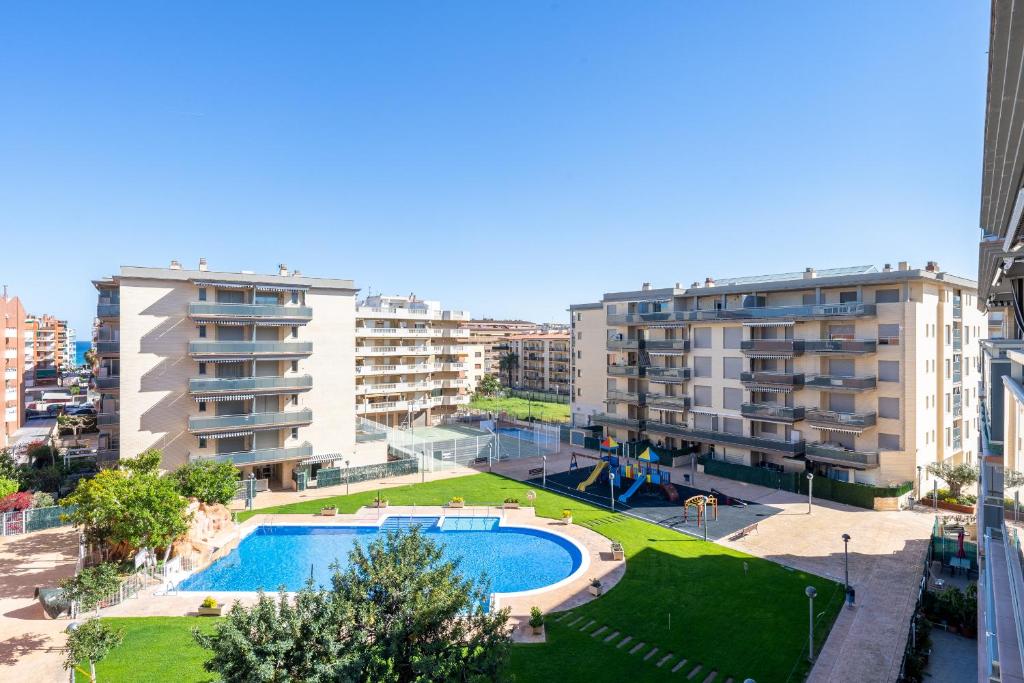 an apartment complex with a swimming pool and buildings at Alea Rentals - Maldivas in La Pineda