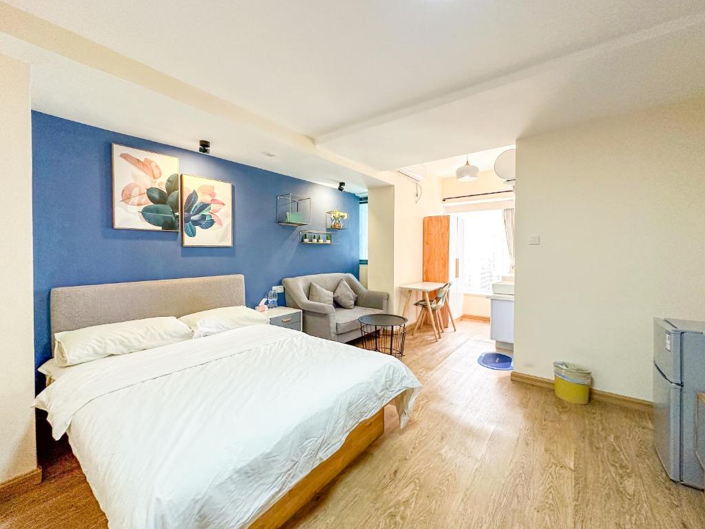 - une chambre avec un lit et un mur bleu dans l'établissement 深圳LaCave公寓, à Shenzhen