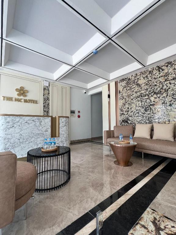 a lobby with a couch and a table at The MC hotel mộc châu in Mộc Châu