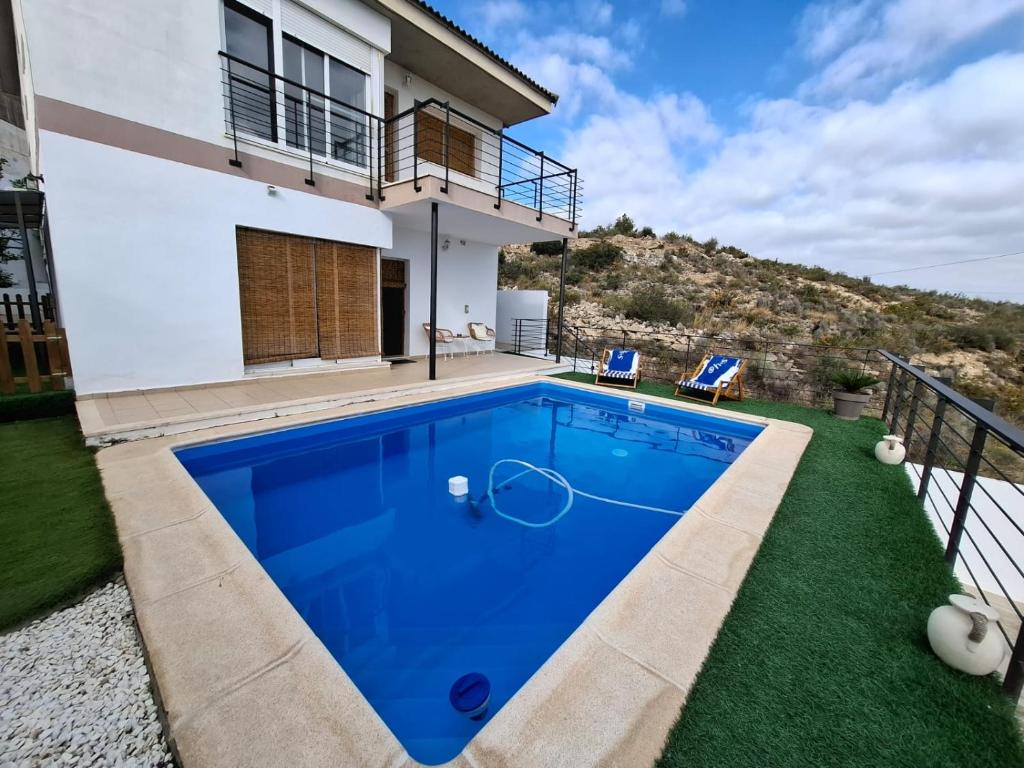 a swimming pool in the backyard of a house at 3 Bed Chalet-Pool-Pets-Hot Tub-Parking-Garden in Chiva