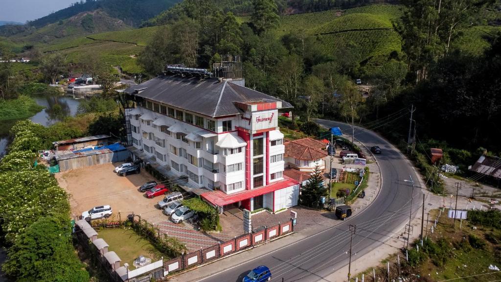 a building on the side of a road next to a road at HillView Munnar in Munnar