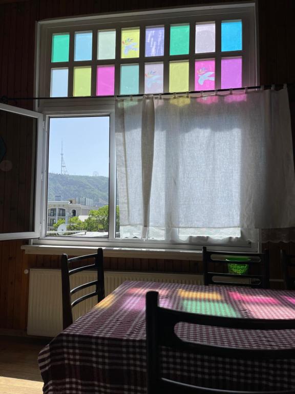 a room with a table and a window with a table at Guest House Third Floor in Tbilisi City