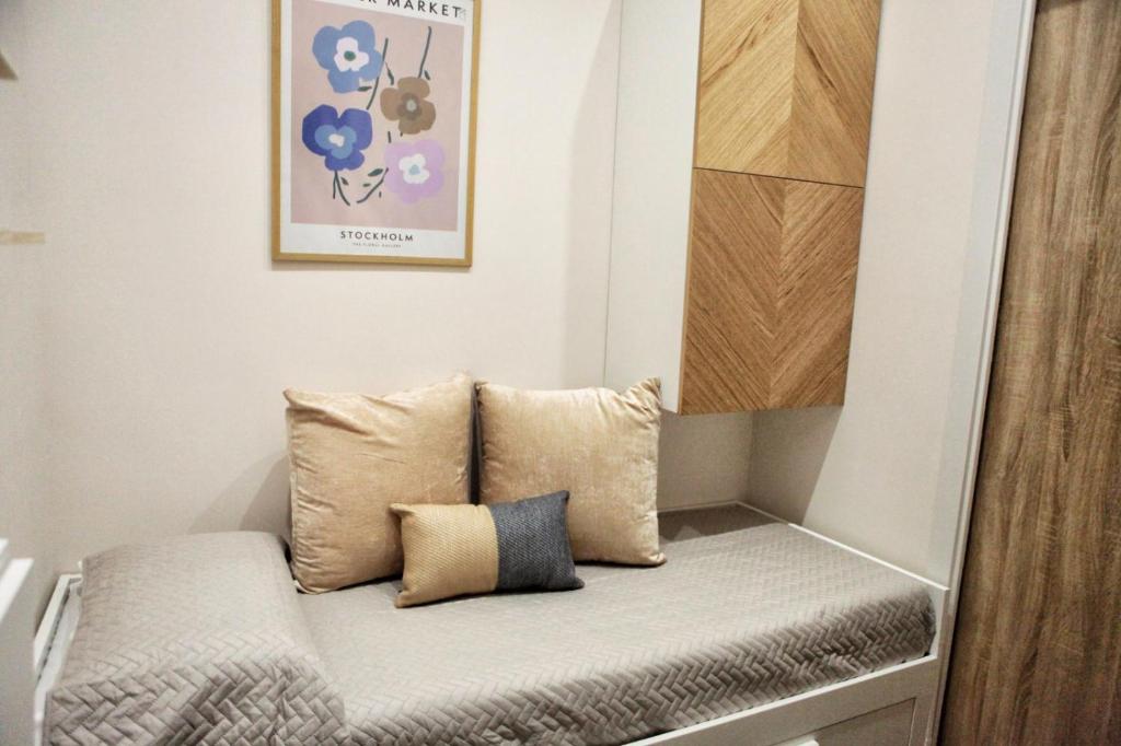 un banco en una pequeña habitación con almohadas en MINIROOMS en Volla