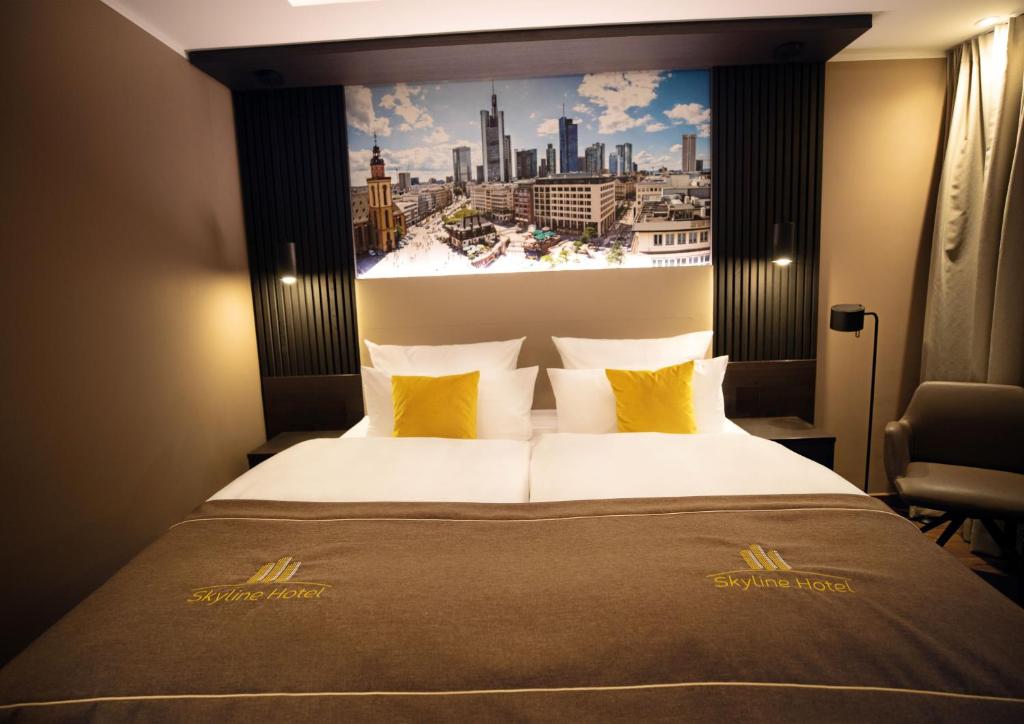 a hotel room with a large bed with a city view at Skyline Hotel City Frankfurt in Frankfurt/Main