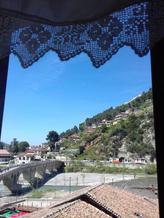 a view of a bridge from a window at Dhimitri's guest house in Berat