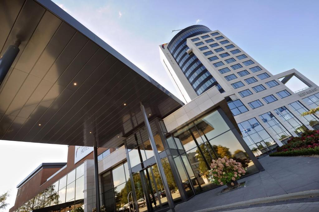 a large building with a tall building at Van der Valk Hotel Tiel in Tiel