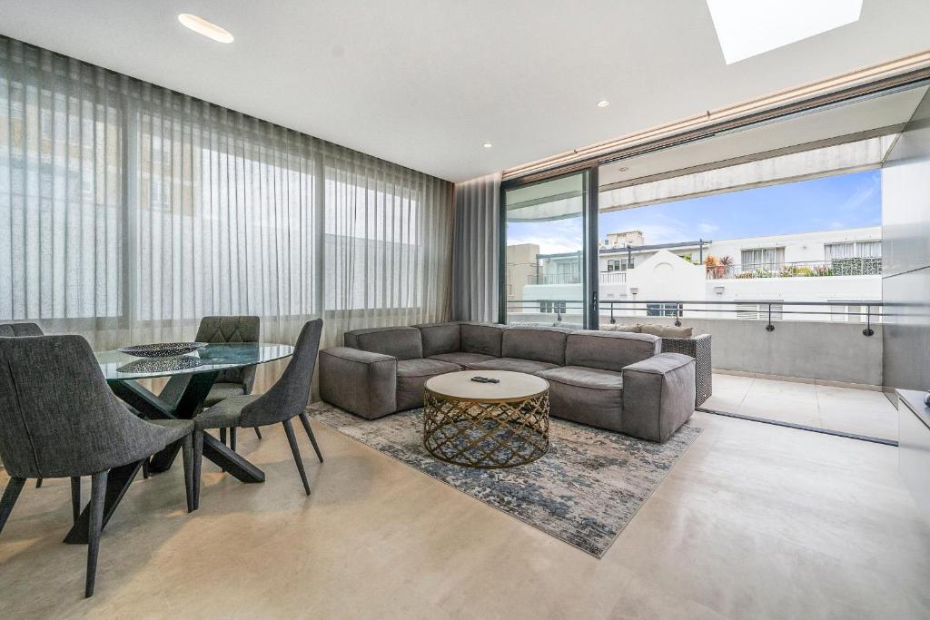 a living room with a couch and a table at The Shore 7 Coogee Beach in Sydney