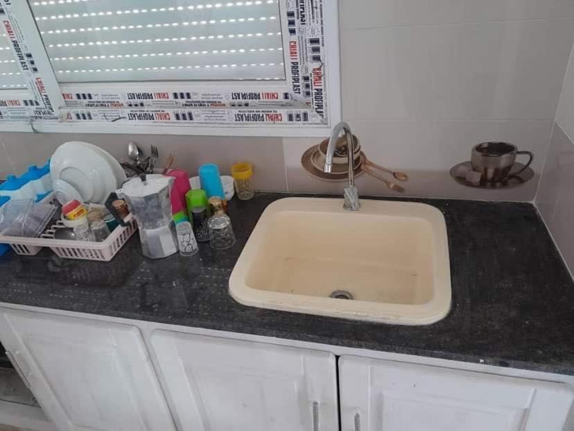 a kitchen counter with a sink in a kitchen at Plage in Douar Chaïb Rasso