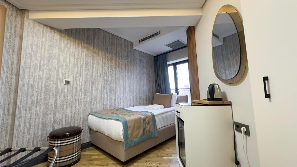 Säng eller sängar i ett rum på Avcı Palace Hotel