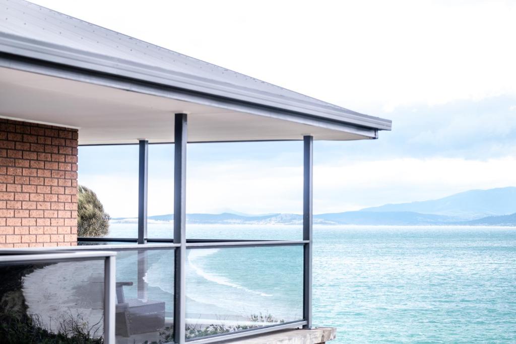 a house with a view of the ocean at Stones Throw in Primrose Sands