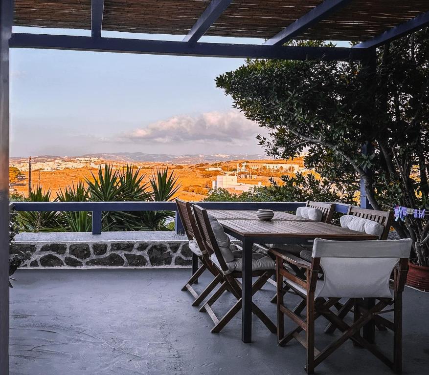 a table and chairs on a patio with a view at 'La Casa della Sirena 2' in Plaka Milou