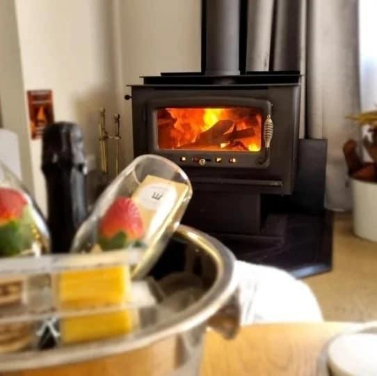 a kitchen with a stove with a fire in it at Hahndorf House B&B in Hahndorf