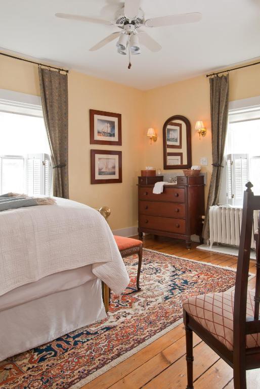 a bedroom with a bed and a dresser at Marshall Slocum Inn in Newport