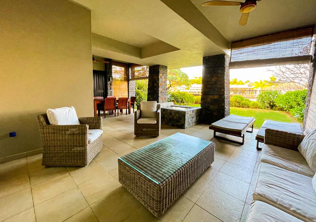 a living room with couches and chairs and a table at Private Beach 5-star Villa, Golf & Luxe in Centre de Flacq