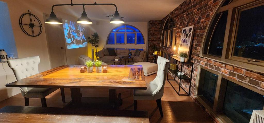 a dining room with a table and a fireplace at 2 Bedroom Penthouse at Suntrust Capitol Plaza, Diliman, Quezon City in Manila