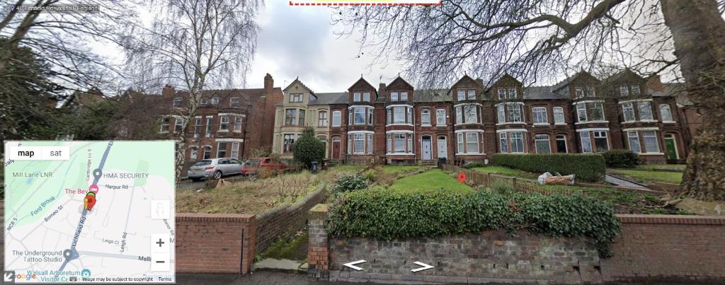 a large brick building with a sign in front of it at Lovely Bedroom with Free parking in Walsall