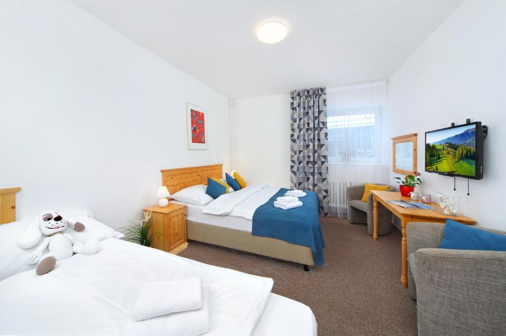 Postel nebo postele na pokoji v ubytování Hotel Lenka