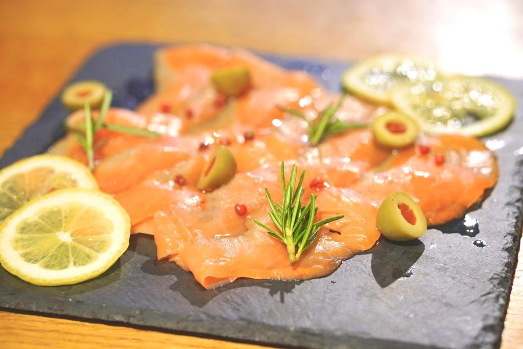 a plate of food with salmon and lemon slices at Henn na Hotel Tokyo Akasaka in Tokyo