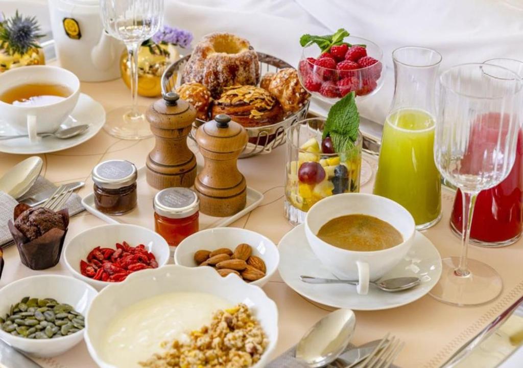 a table topped with dishes of food and drinks at 9Confidentiel in Paris