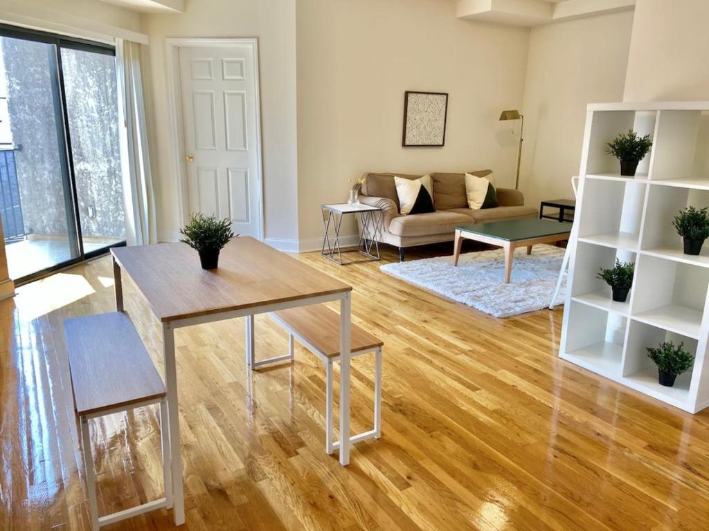 a living room with a table and a couch at 124-2 Bedroom 2 Bath Apt in Heart of Hoboken in Hoboken