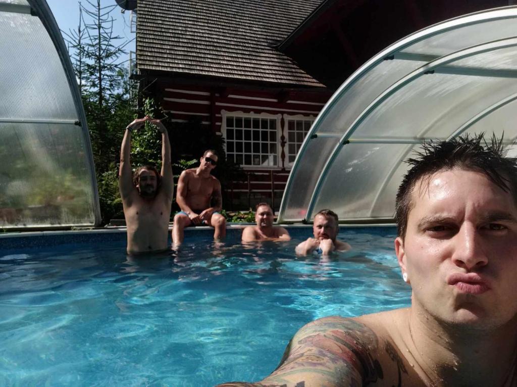 a group of men sitting in a swimming pool at Mlýn u skály in Deštné v Orlických horách