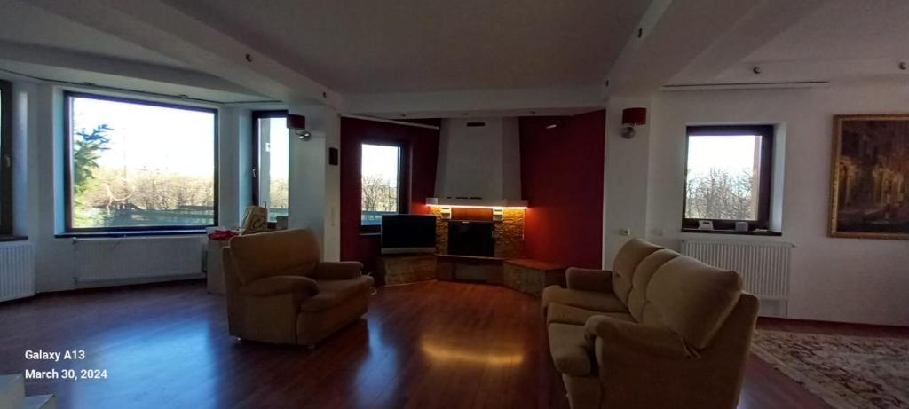 a living room with two chairs and a couch at Villa VanDerVar-7rooms, long term rental, 29 euro per day, min 4 rooms, min 3 months with invoice in Iaşi