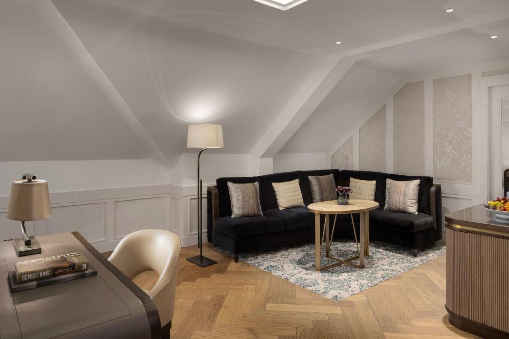 a living room with a couch and a table at The Biltmore Mayfair in London