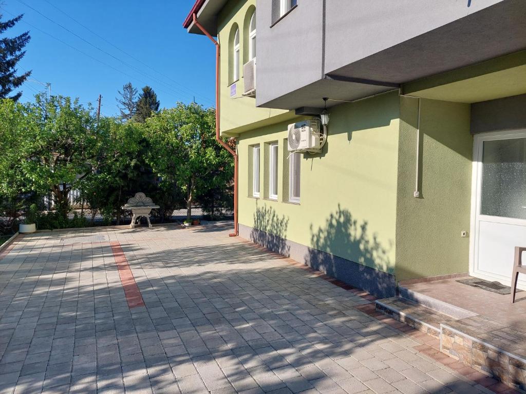 a building with a brick driveway in front of it at Mateski guest house in Ohrid