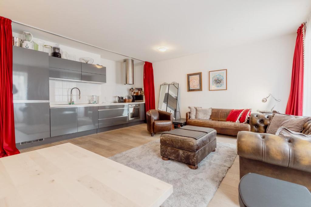 un soggiorno con divano e tavolo di Appartement spacieux à 15 minutes du jet d'eau a Ginevra