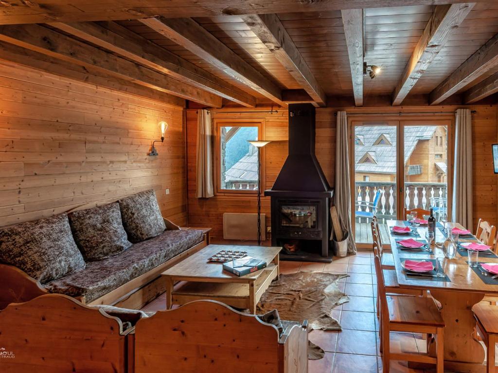 a living room with a couch and a stove at Chalet Pra-Loup, 4 pièces, 10 personnes - FR-1-165A-47 in Uvernet