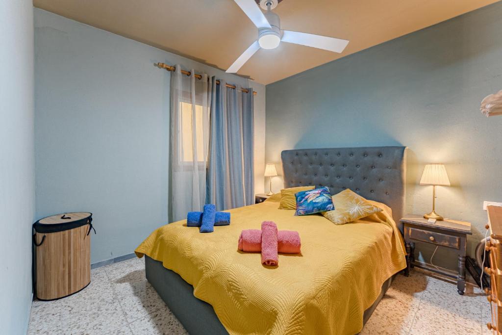 a bedroom with a bed with two towels on it at Emerald auténtic canary apartment in Arona
