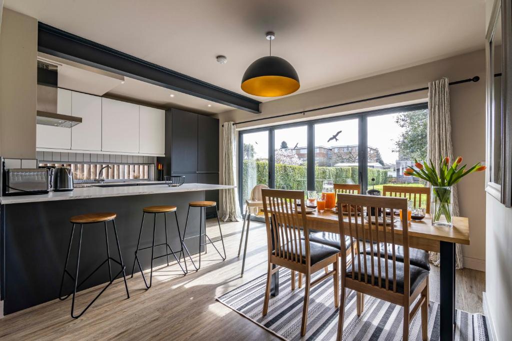 een keuken en eetkamer met een tafel en stoelen bij SPACIOUS HOME WITH GARDEN-SLEEPS 5 Contractors, families, and group stays welcome in Beeston