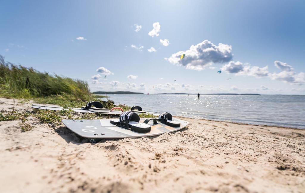 a group of snowboards sitting on the sand on a beach at Apartments Waterfront in Sagard