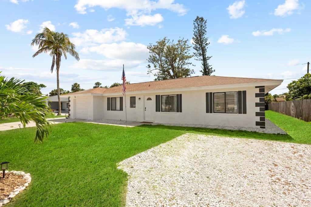 a house with a flag in a yard at Brand New 2Bed in Bonita's Heart with Superb Patio and Garden in Bonita Springs