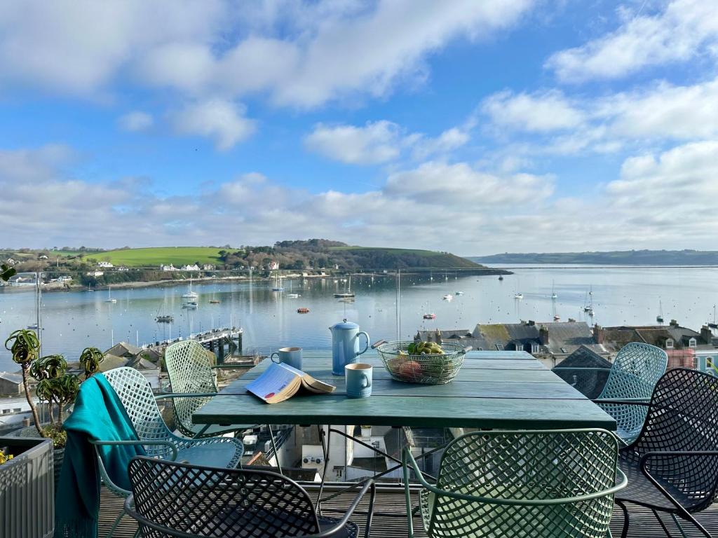a table on a balcony with a view of the water at Jacob's View in Falmouth
