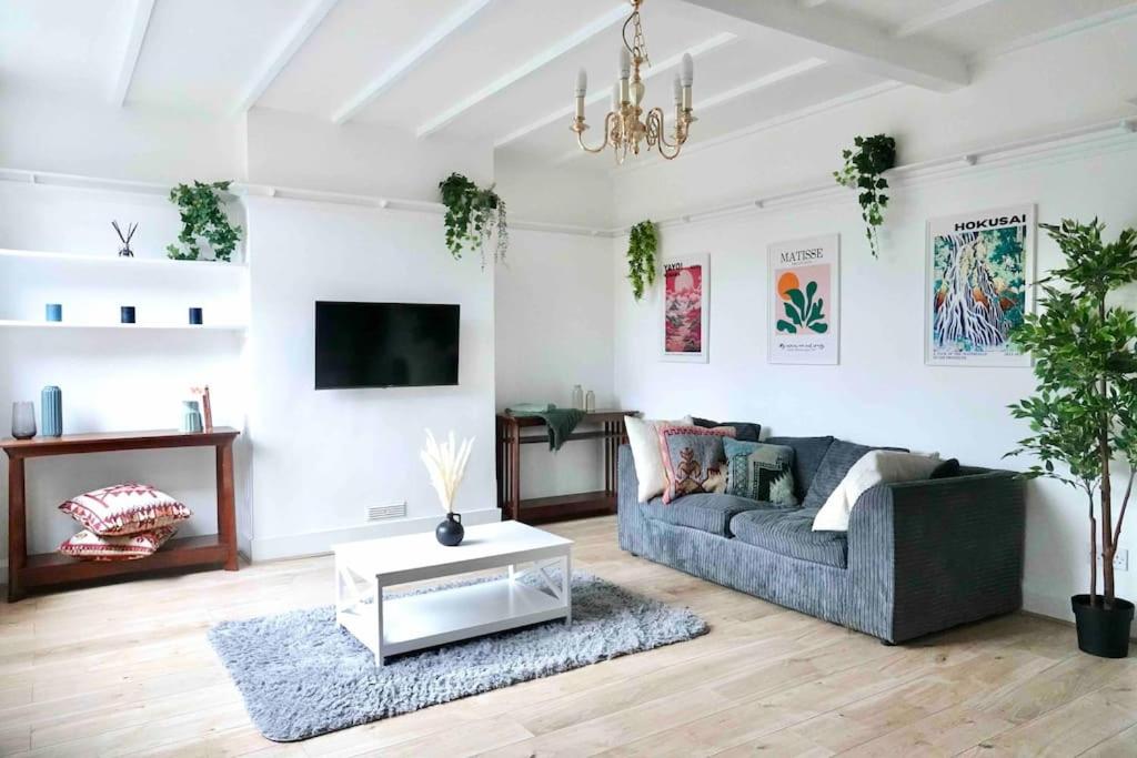 a living room with a couch and a table at 5 Bed Luxury London Home in London