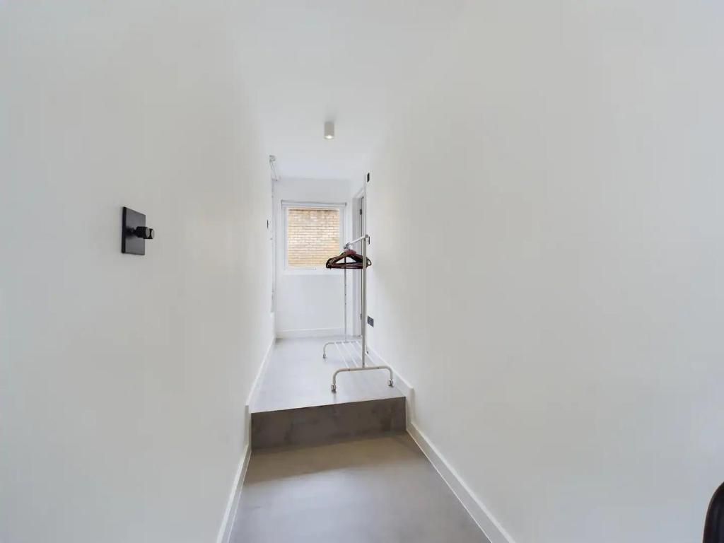 a white room with a window and a sink at Pass the Keys Stylish and Modern 2Bed 2Bath Hackney Apartment in London