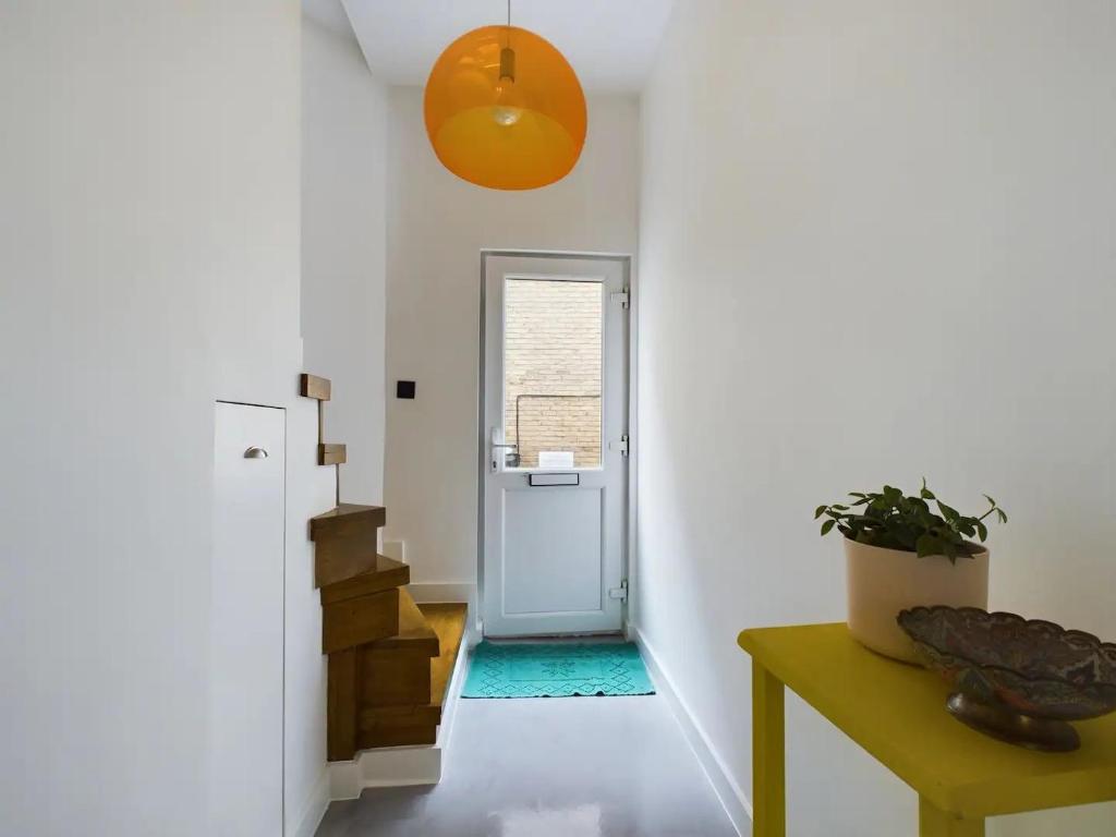 a hallway with white walls and a blue door at Pass the Keys Stylish and Modern 2Bed 2Bath Hackney Apartment in London